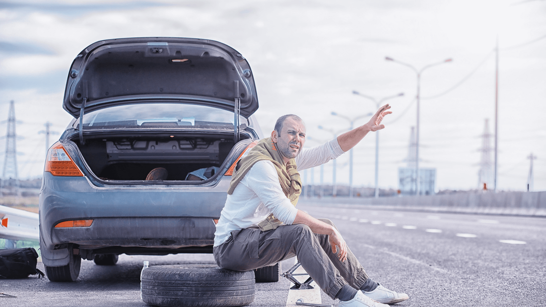 Man sitting on flat tire in st clair shores MI